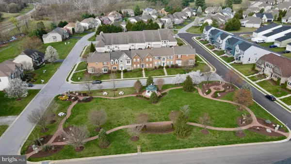 an aerial view of a house with garden space and street view