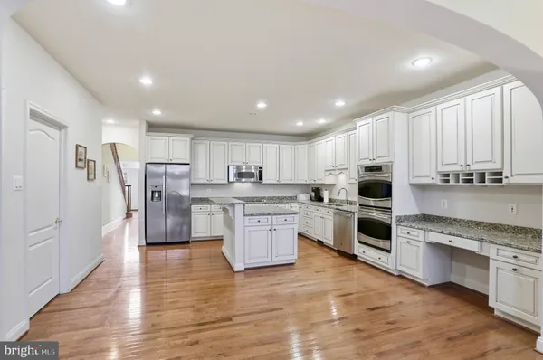 a kitchen with refrigerator and cabinets