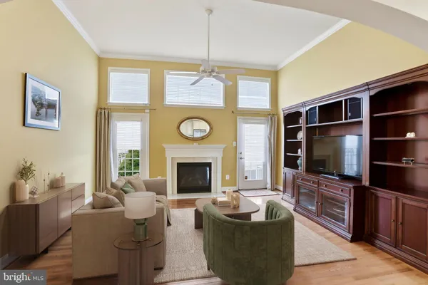 a living room with fireplace furniture a flat screen tv and a window