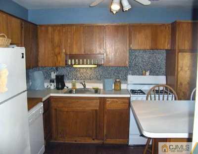 19 Atlantic Road Somerset, NJ 08873 - Photo 3 of 8 a kitchen with a sink a refrigerator and cabinets