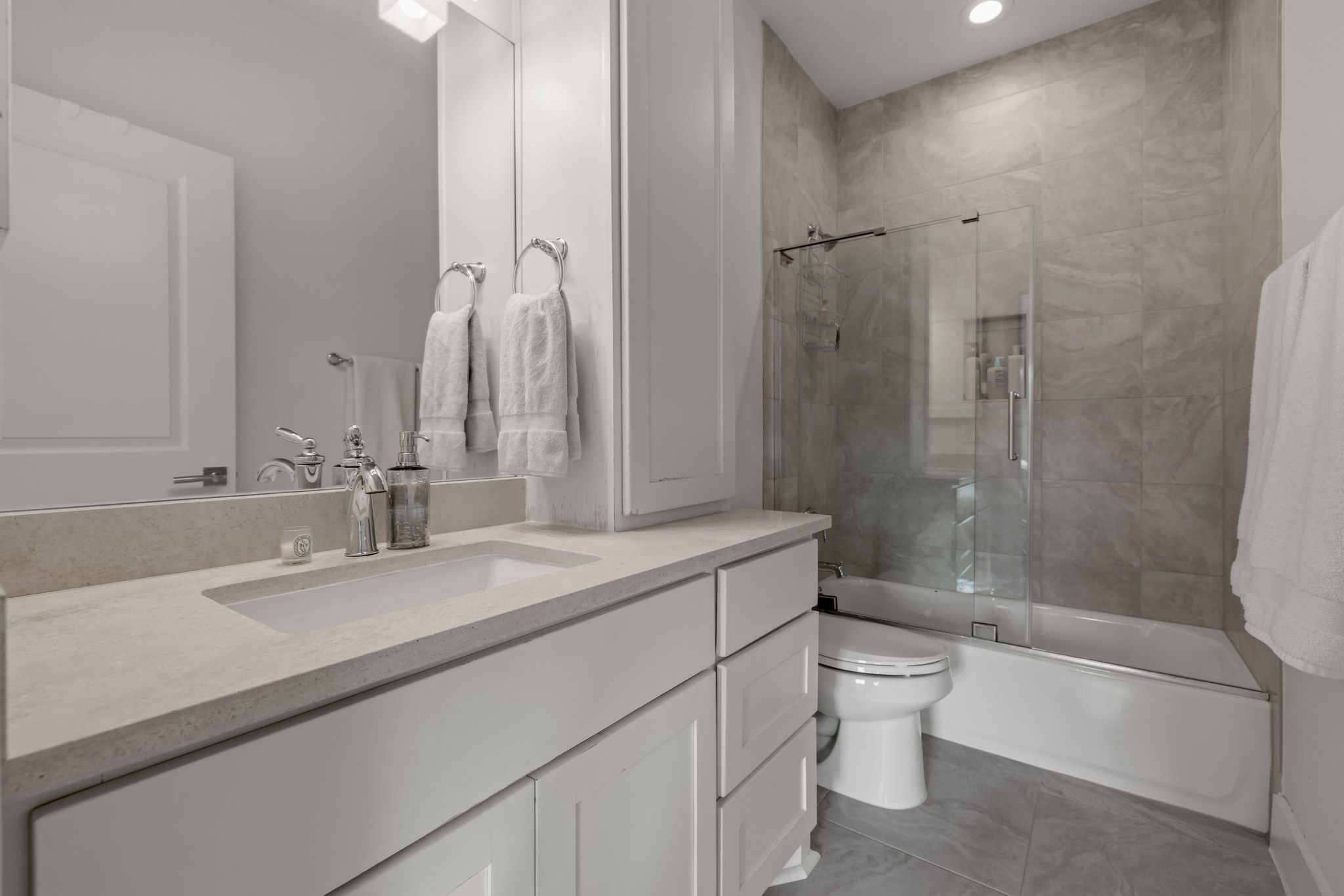 4720 Rockcliff Road, Unit 1 Austin, TX 78746 - Photo 37 of 39 Modern bath features a single vanity with abundant storage and a shower-tub combo.