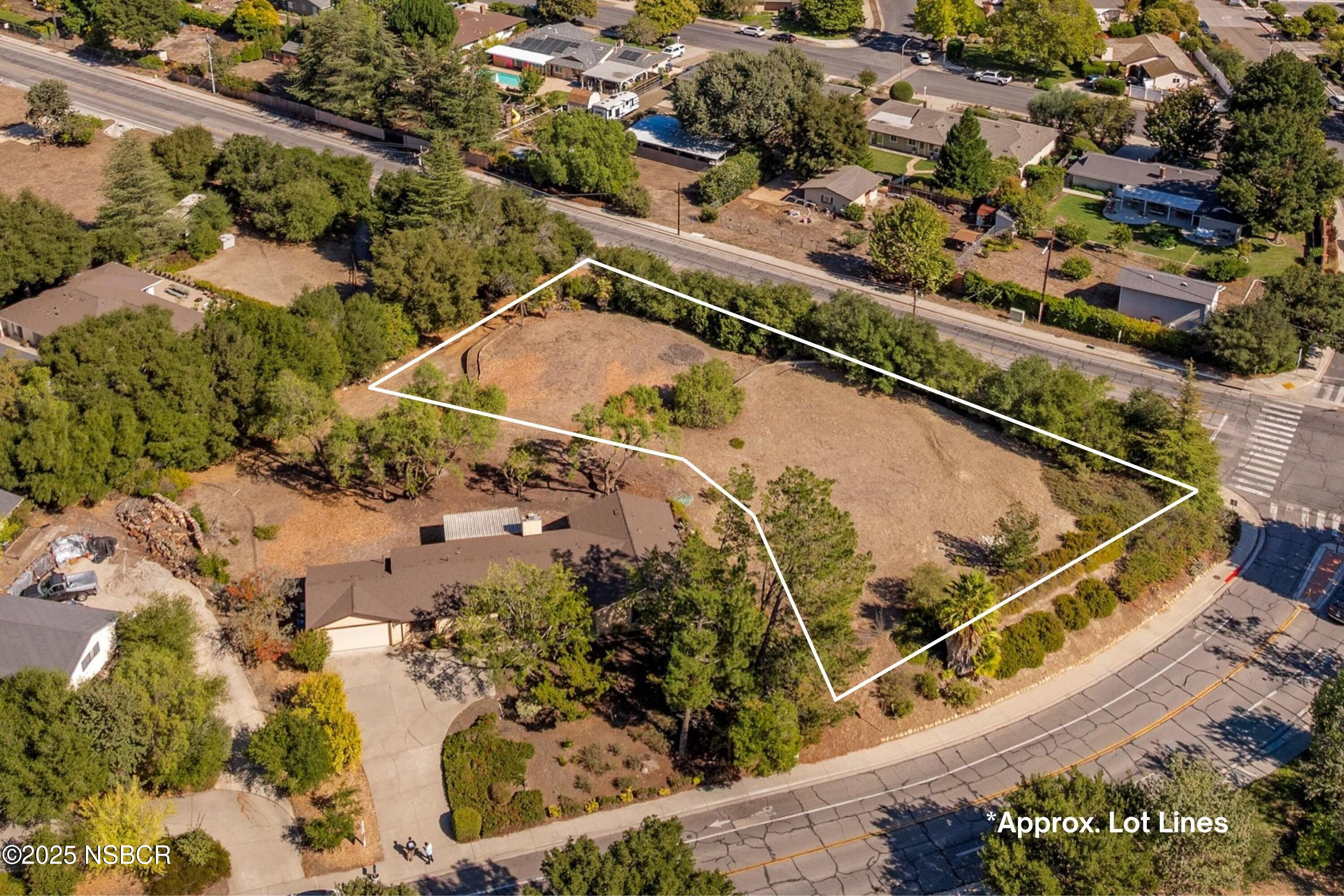 an aerial view of a residential houses with outdoor space