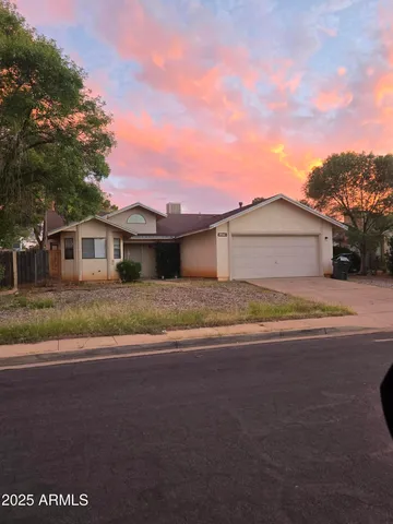 a front view of a house with a yard and a garage