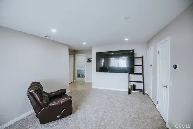 a living room with furniture and a projector screen