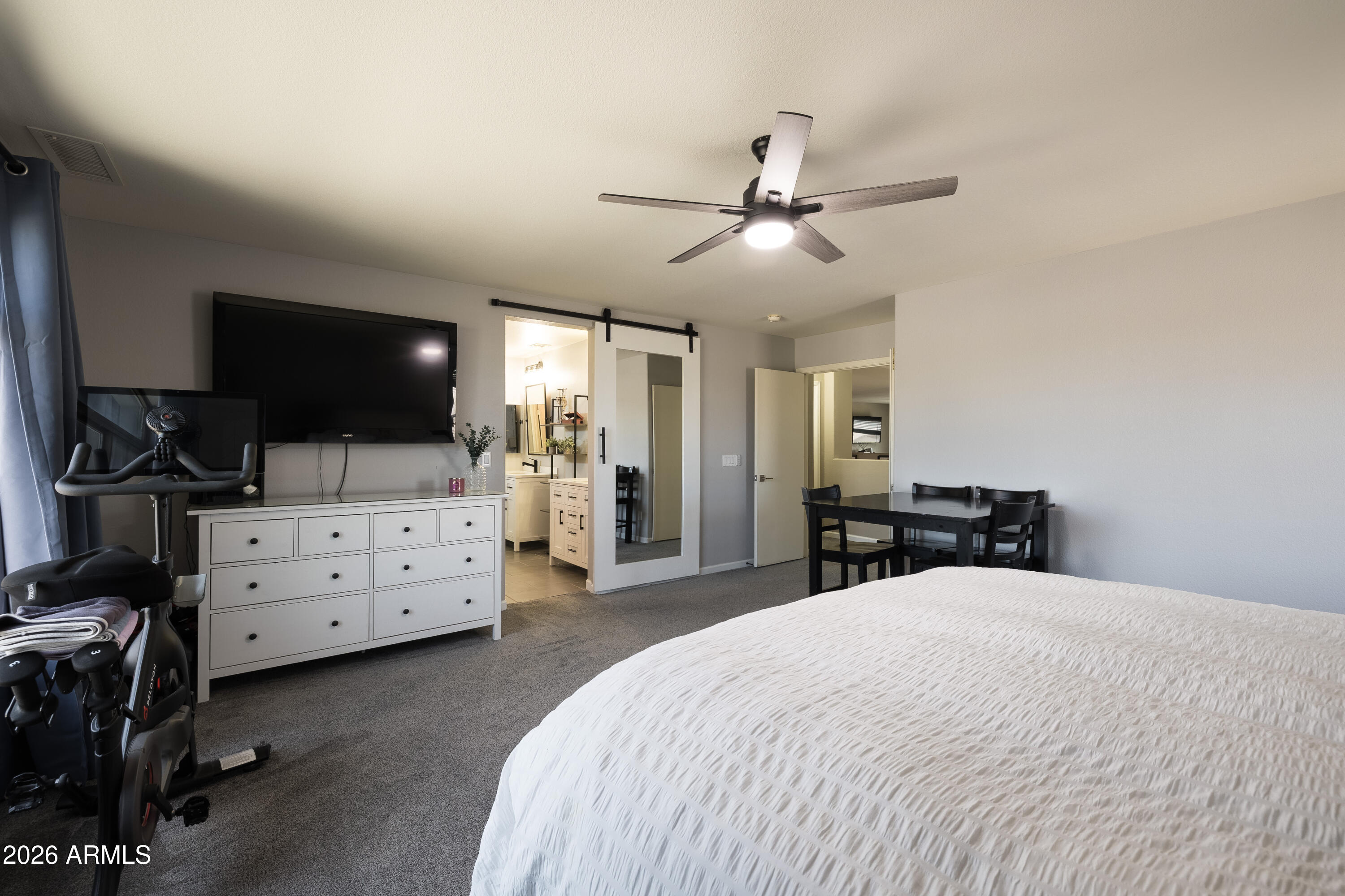 6407 West Saddlehorn Road Phoenix, AZ 85083 - Photo 36 of 41 a bed room with a bed and a flat tv screen on the dresser
