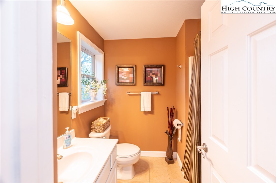 309 Pinnacle Ridge Road Beech Mountain, NC 28604 - Photo 19 of 45 a bathroom with a granite countertop toilet and a sink