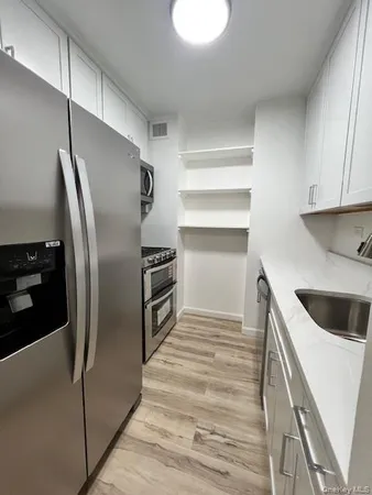 a kitchen with cabinets and stainless steel appliances