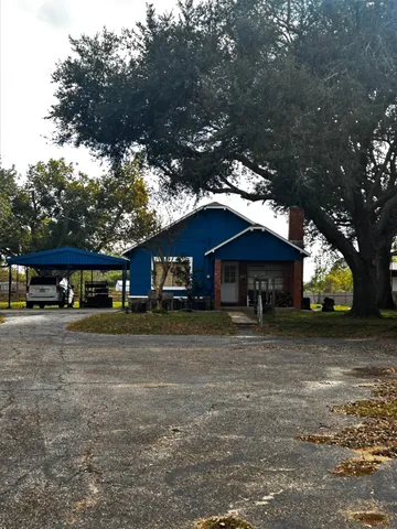 a house that has a tree in front of it