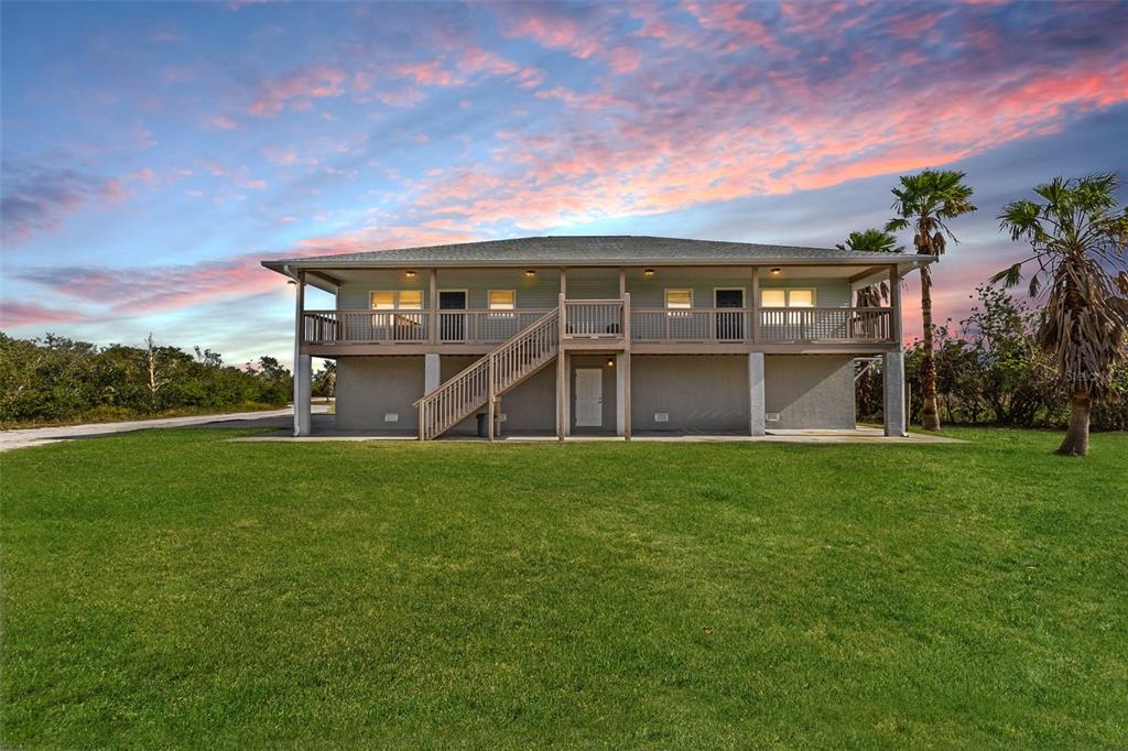 445 Horseshoe Loop Road Terra Ceia, FL 34250 - Photo 2 of 65 front view of house with a yard