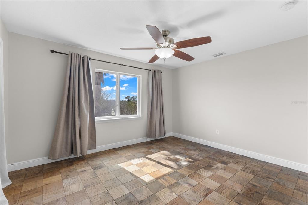 445 Horseshoe Loop Road Terra Ceia, FL 34250 - Photo 21 of 65 an empty room with windows and fan