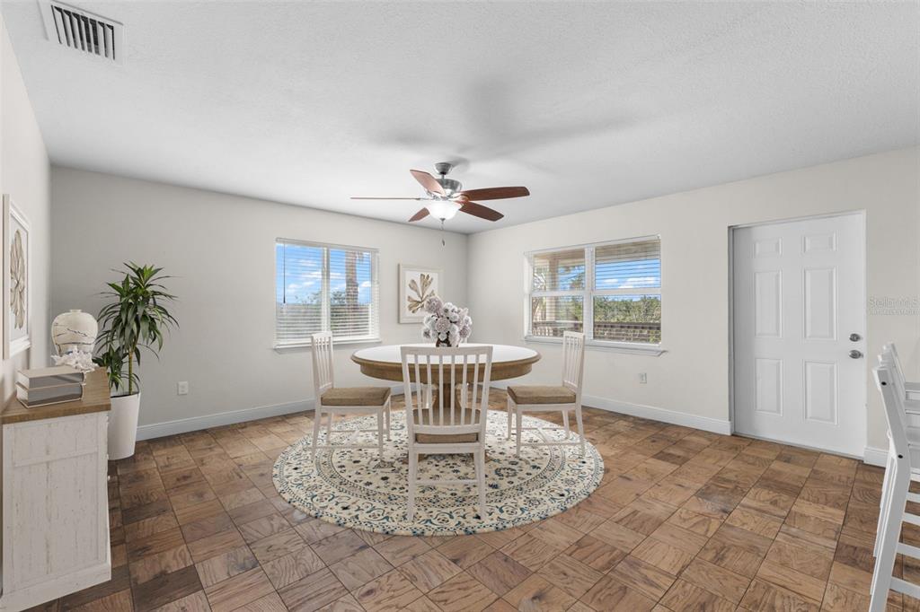 445 Horseshoe Loop Road Terra Ceia, FL 34250 - Photo 6 of 65 a dining room with wooden floor and a potted plant