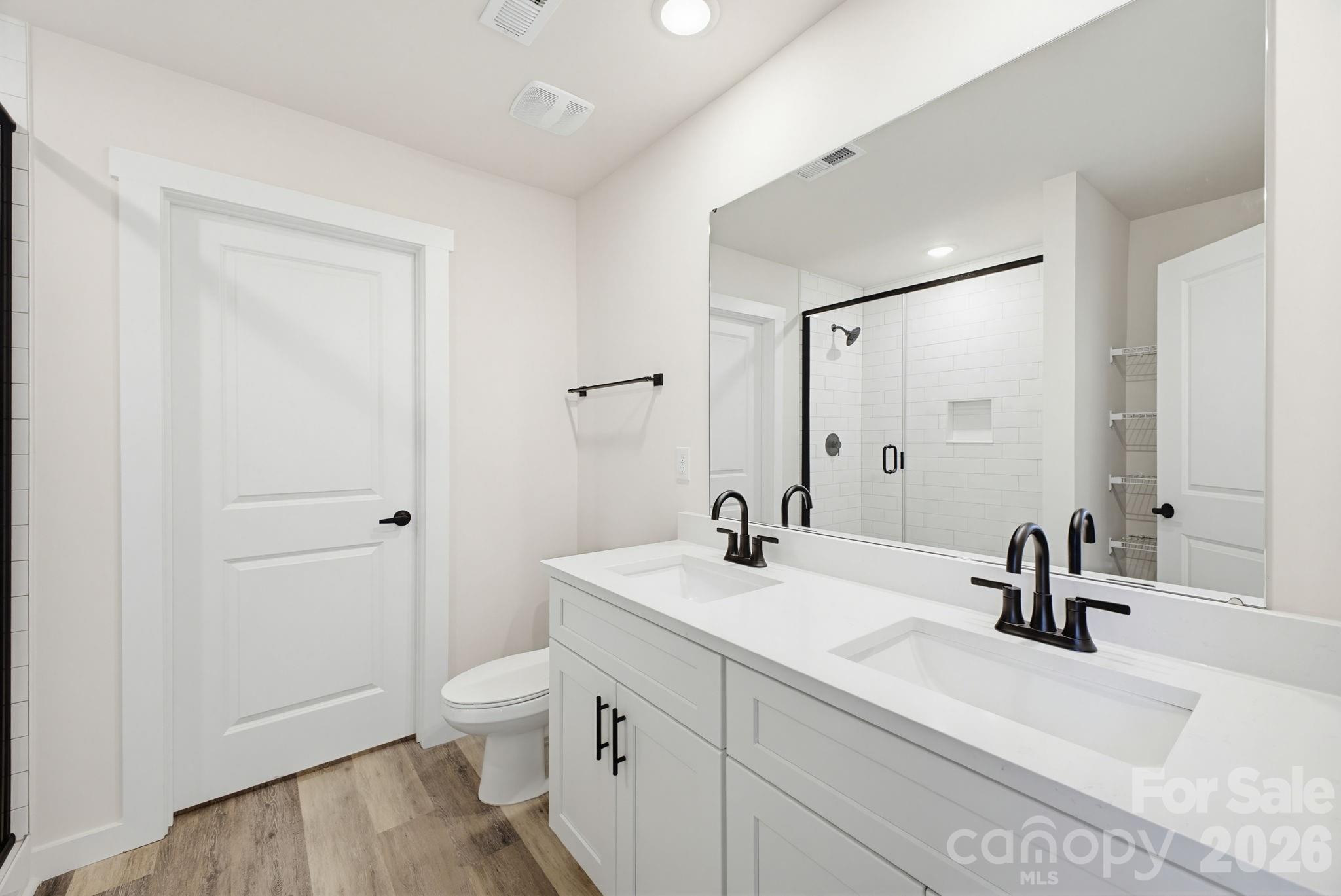 2323 Merts Way, Unit 1 Hudson, NC 28638 - Photo 12 of 15 a bathroom with a sink a toilet and a large mirror