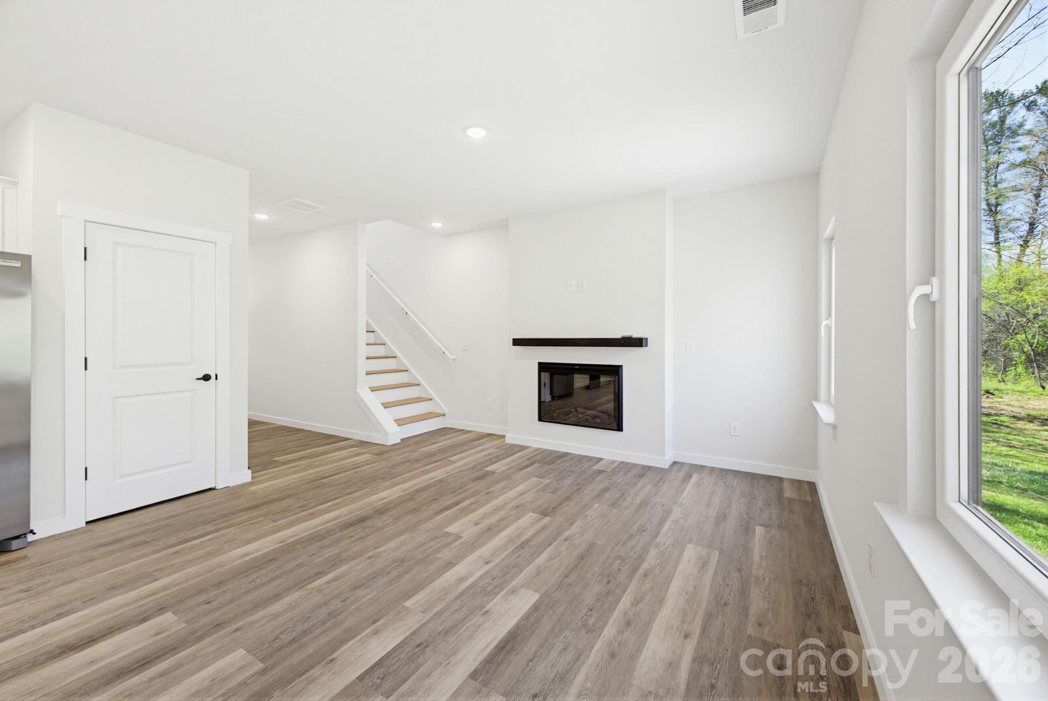 2323 Merts Way, Unit 1 Hudson, NC 28638 - Photo 3 of 15 a view of empty room with wooden floor and fireplace