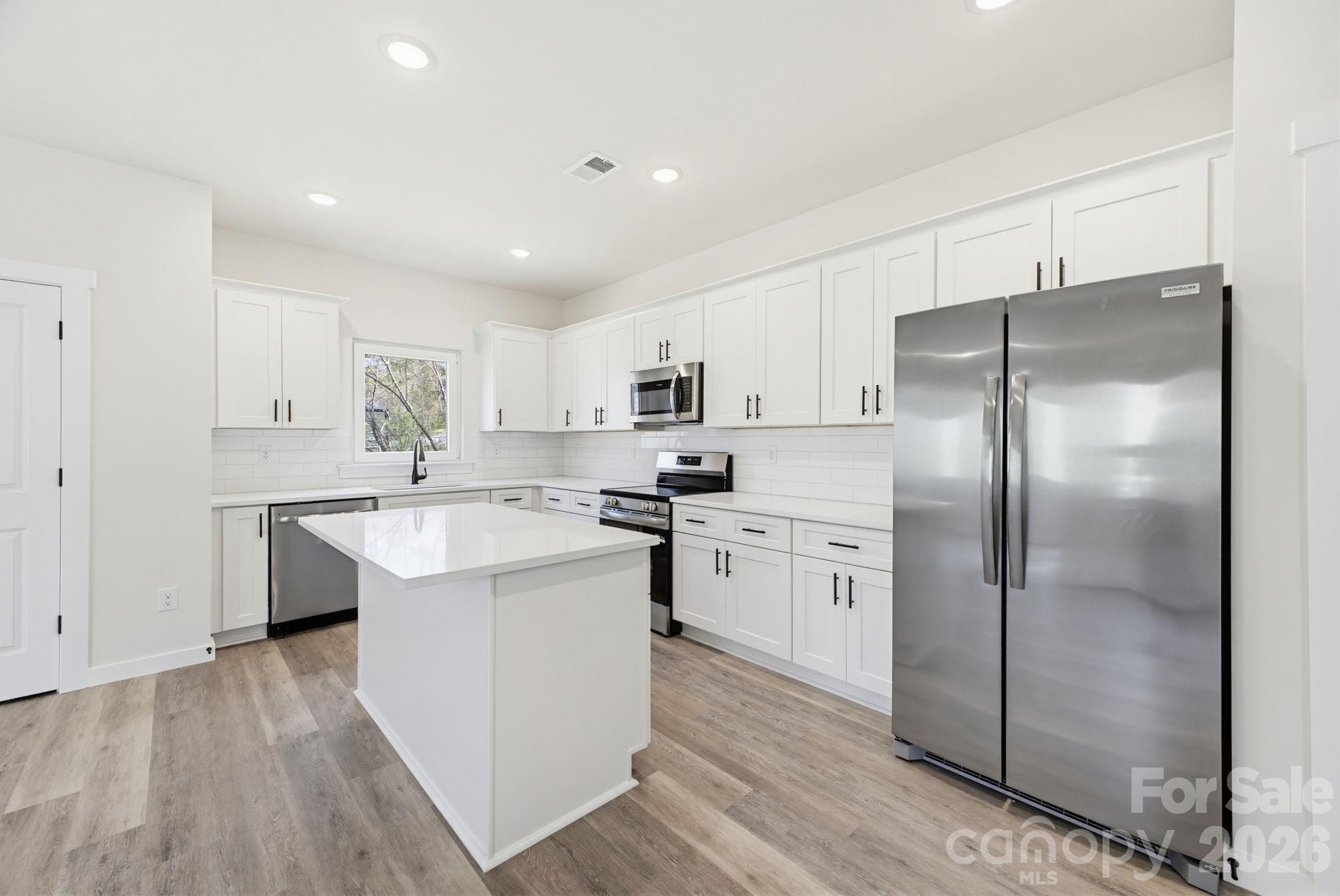 2323 Merts Way, Unit 1 Hudson, NC 28638 - Photo 5 of 15 a kitchen with a refrigerator sink and cabinets