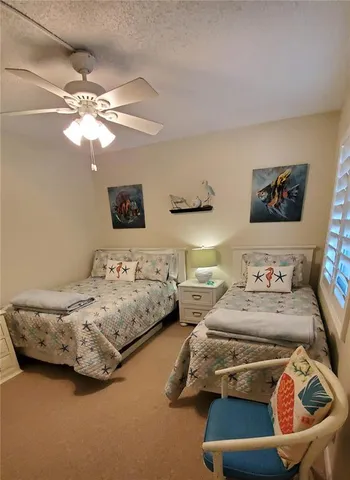 a bedroom with bed and a chandelier