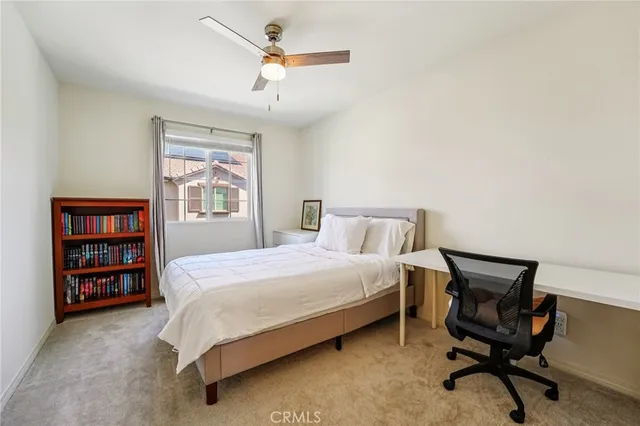 a bedroom with a bed a dresser and book shelf
