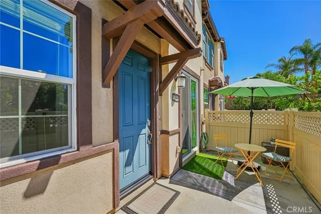 a patio with a patio table and chairs
