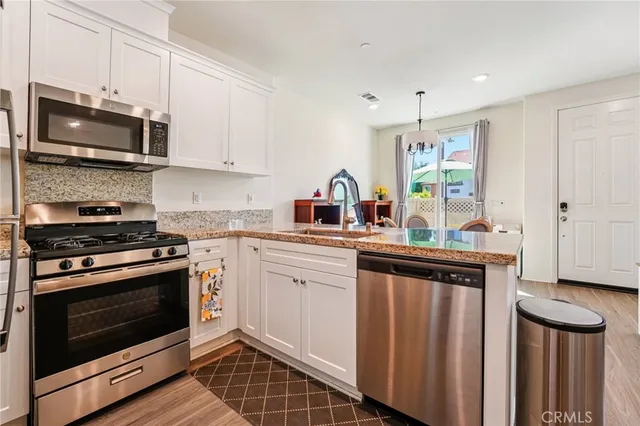 a kitchen with stainless steel appliances a stove a microwave and cabinets