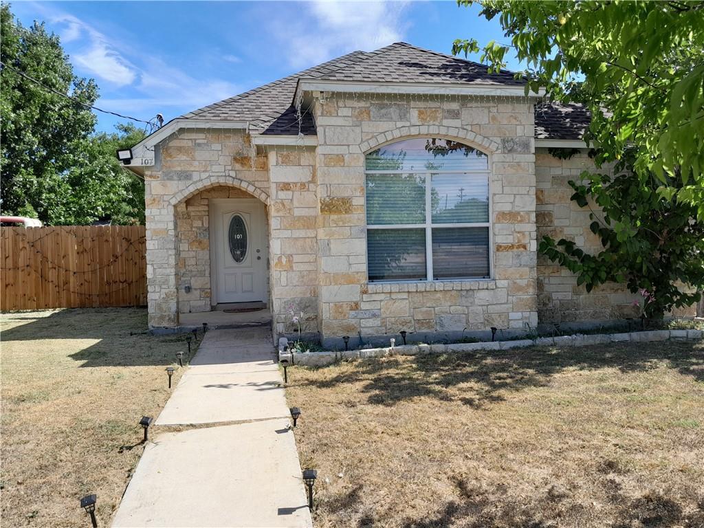 107 East Wheeler Street Manor, TX 78653 - Photo 1 of 7 a front view of a house with a yard