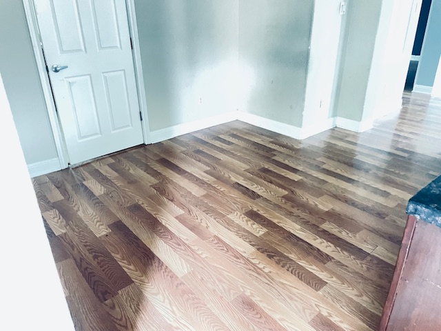 107 East Wheeler Street Manor, TX 78653 - Photo 3 of 7 a view of empty room with wooden floor