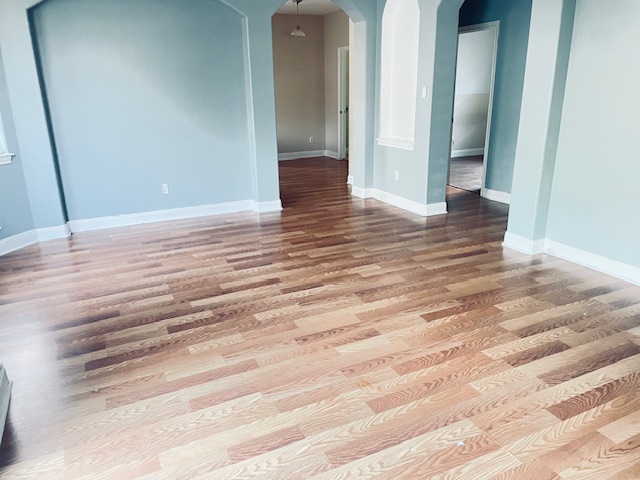 107 East Wheeler Street Manor, TX 78653 - Photo 4 of 7 a view of empty room with wooden floor