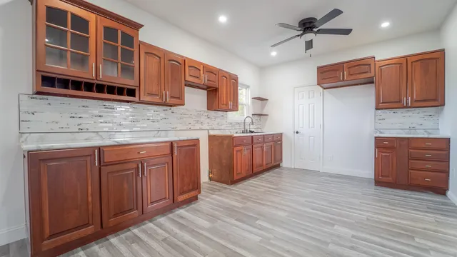 a kitchen with stainless steel appliances granite countertop cabinets and wooden floor
