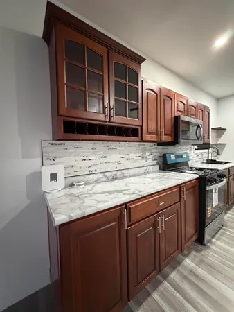 a kitchen with stainless steel appliances granite countertop a stove and a sink