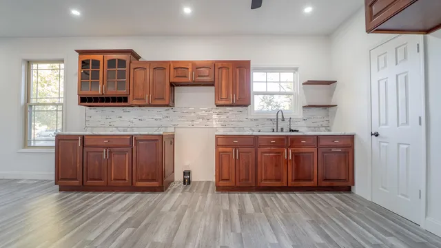 a kitchen with stainless steel appliances granite countertop wooden cabinets a sink and dishwasher
