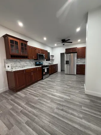 a open kitchen with stainless steel appliances granite countertop a stove and a sink