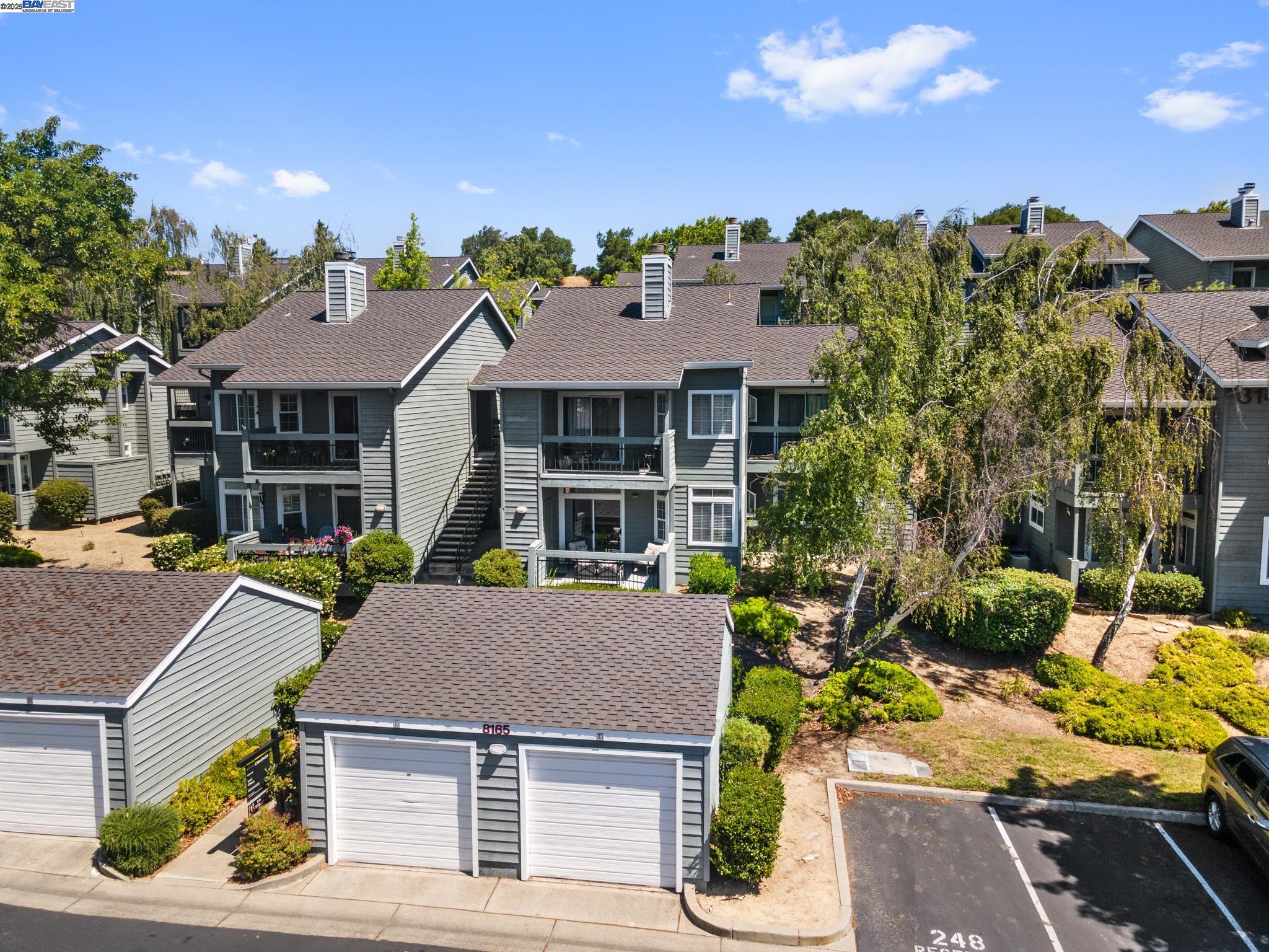 8165 Mountain View Drive, Unit C Pleasanton, CA 94588 - Photo 1 of 35 a aerial view of a house with a garden and plants