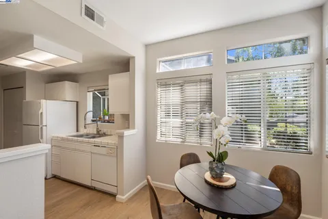 a kitchen with a table and chairs