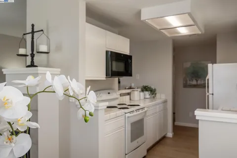 a kitchen with a sink and chairs