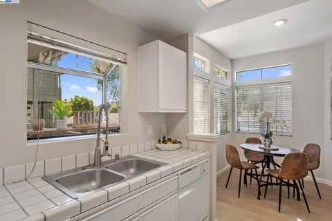 a kitchen with a stove a sink a microwave and dining table