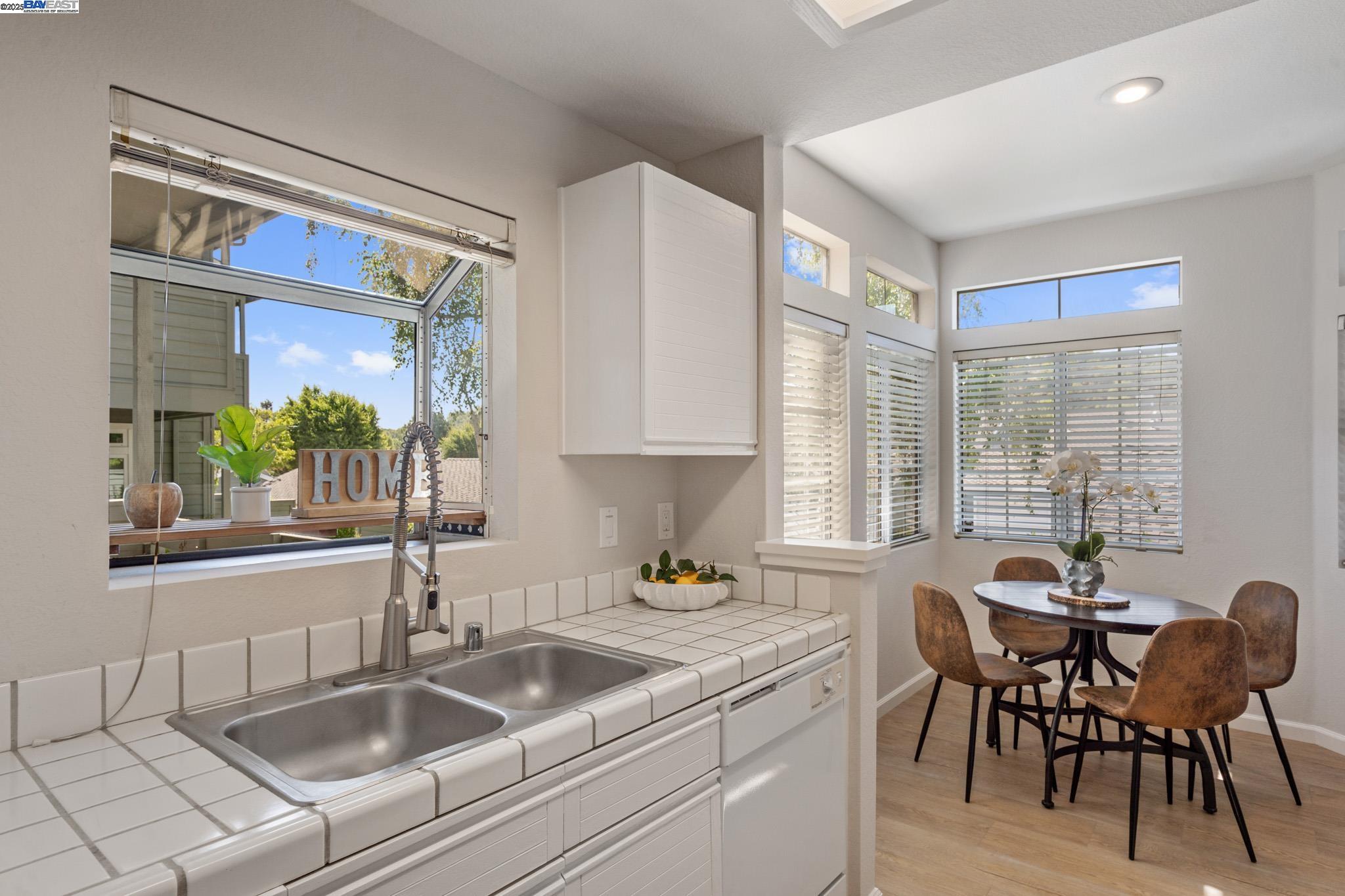 8165 Mountain View Drive, Unit C Pleasanton, CA 94588 - Photo 13 of 35 a kitchen with a sink and chairs