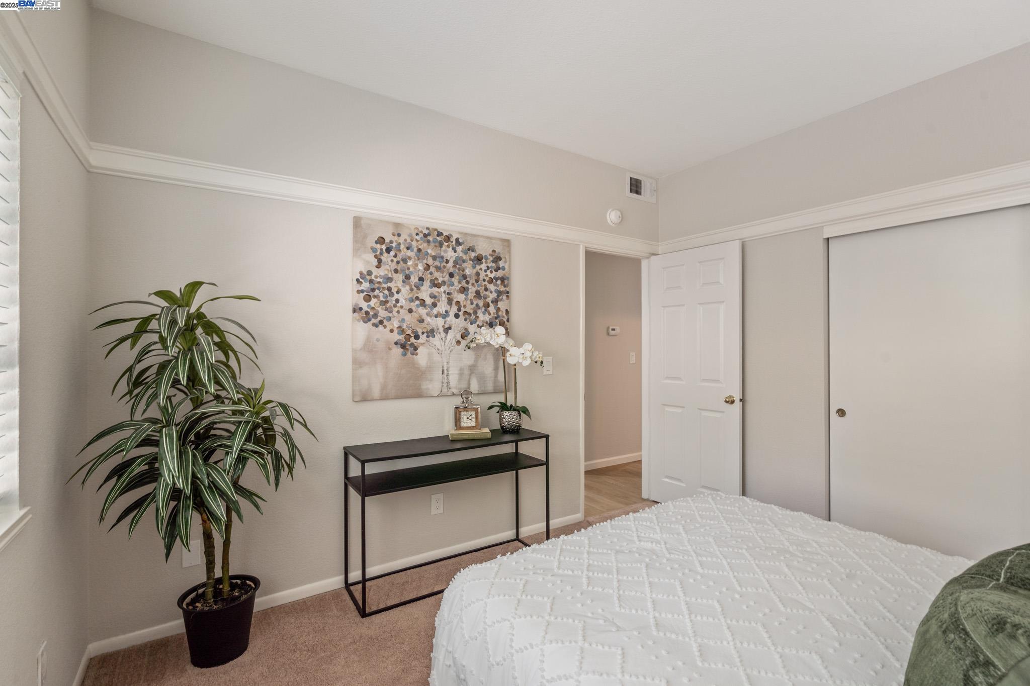 8165 Mountain View Drive, Unit C Pleasanton, CA 94588 - Photo 19 of 35 a bedroom with furniture and a potted plant