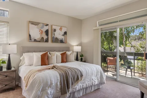 a bedroom with a large bed and a window