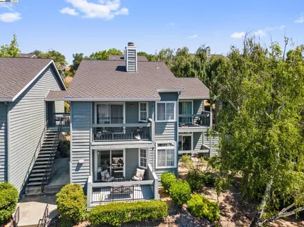 a front view of a house with yard and green space