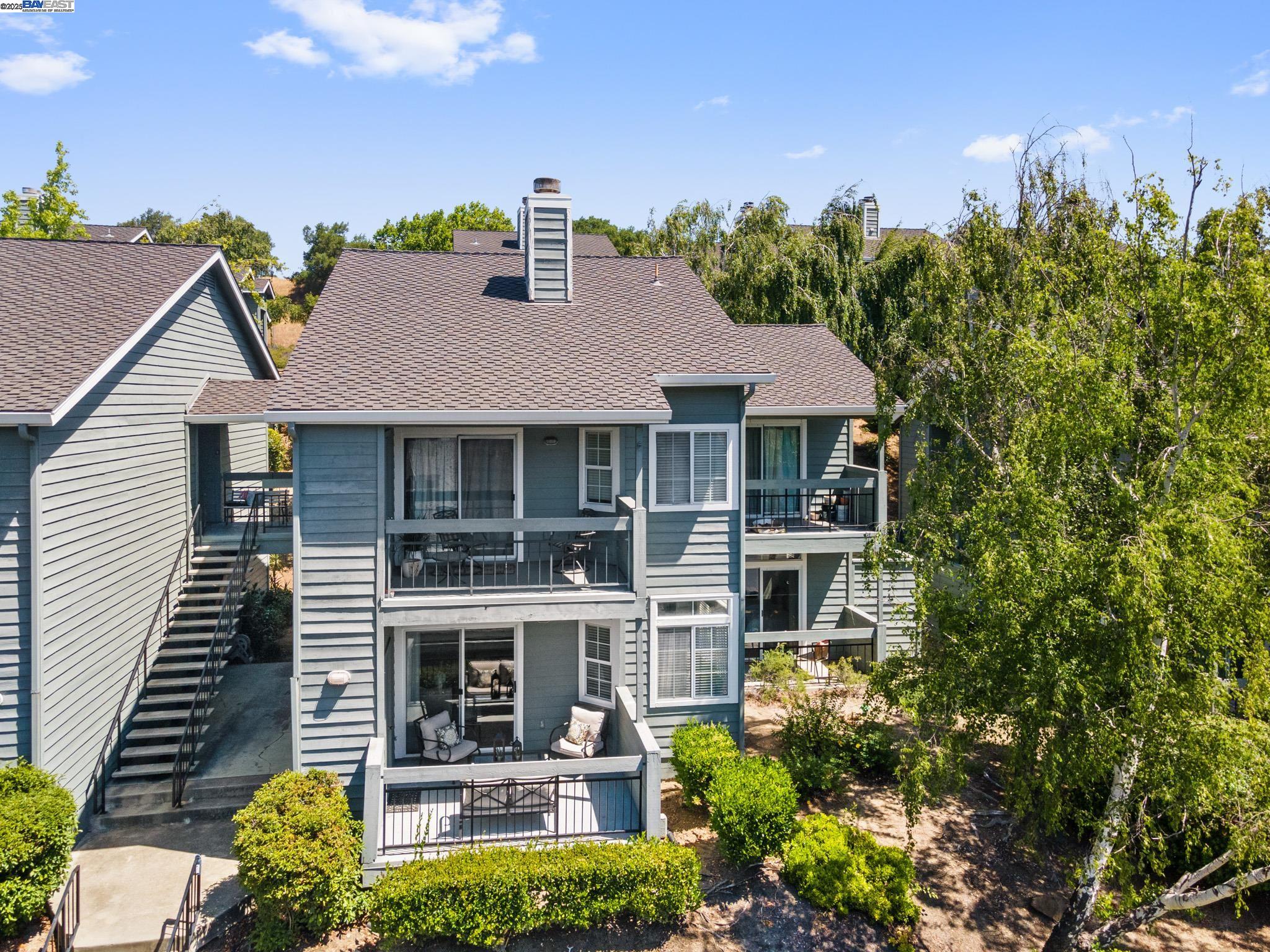 8165 Mountain View Drive, Unit C Pleasanton, CA 94588 - Photo 2 of 35 a front view of a house with yard and green space