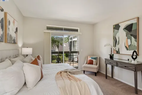 a view of a balcony with wooden floor and outdoor seating