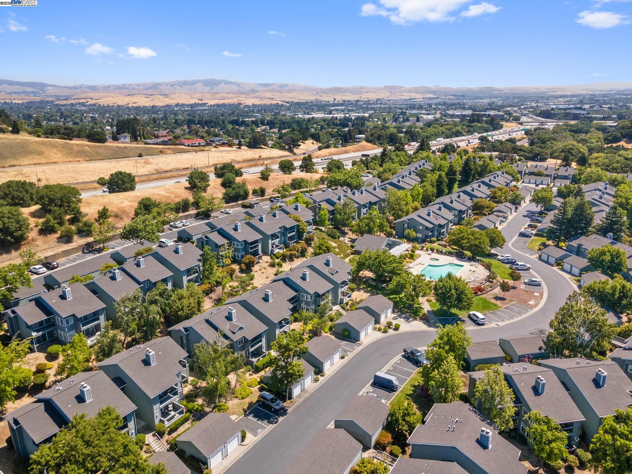 8165 Mountain View Drive, Unit C Pleasanton, CA 94588 - Photo 34 of 35 an aerial view of a city with lots of residential buildings and mountain view in back
