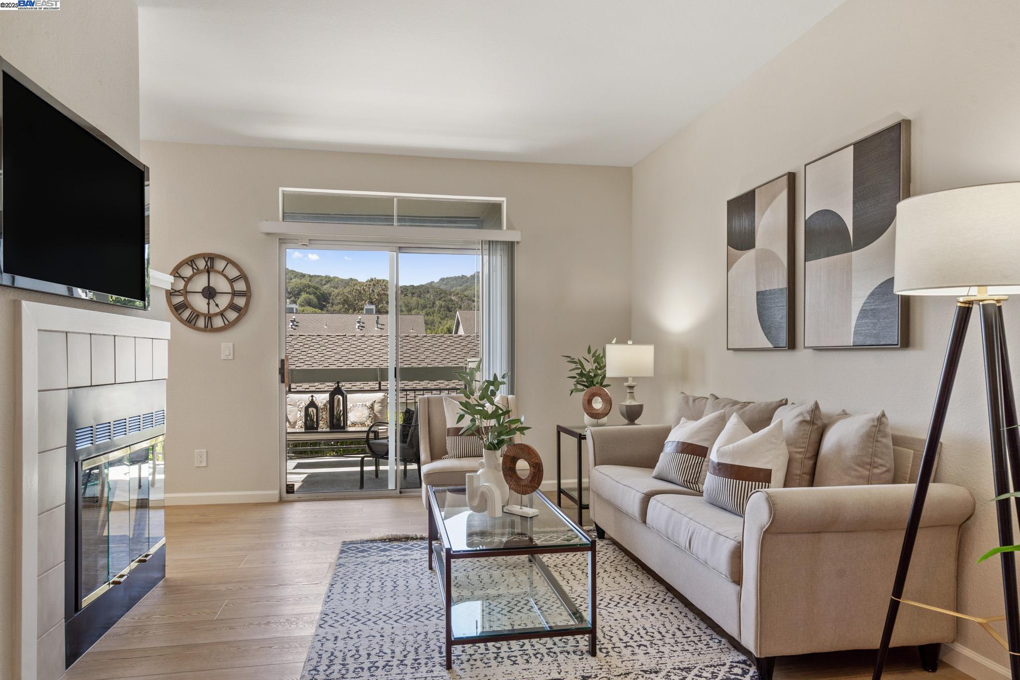 8165 Mountain View Drive, Unit C Pleasanton, CA 94588 - Photo 5 of 35 a living room with furniture a flat screen tv and a fireplace