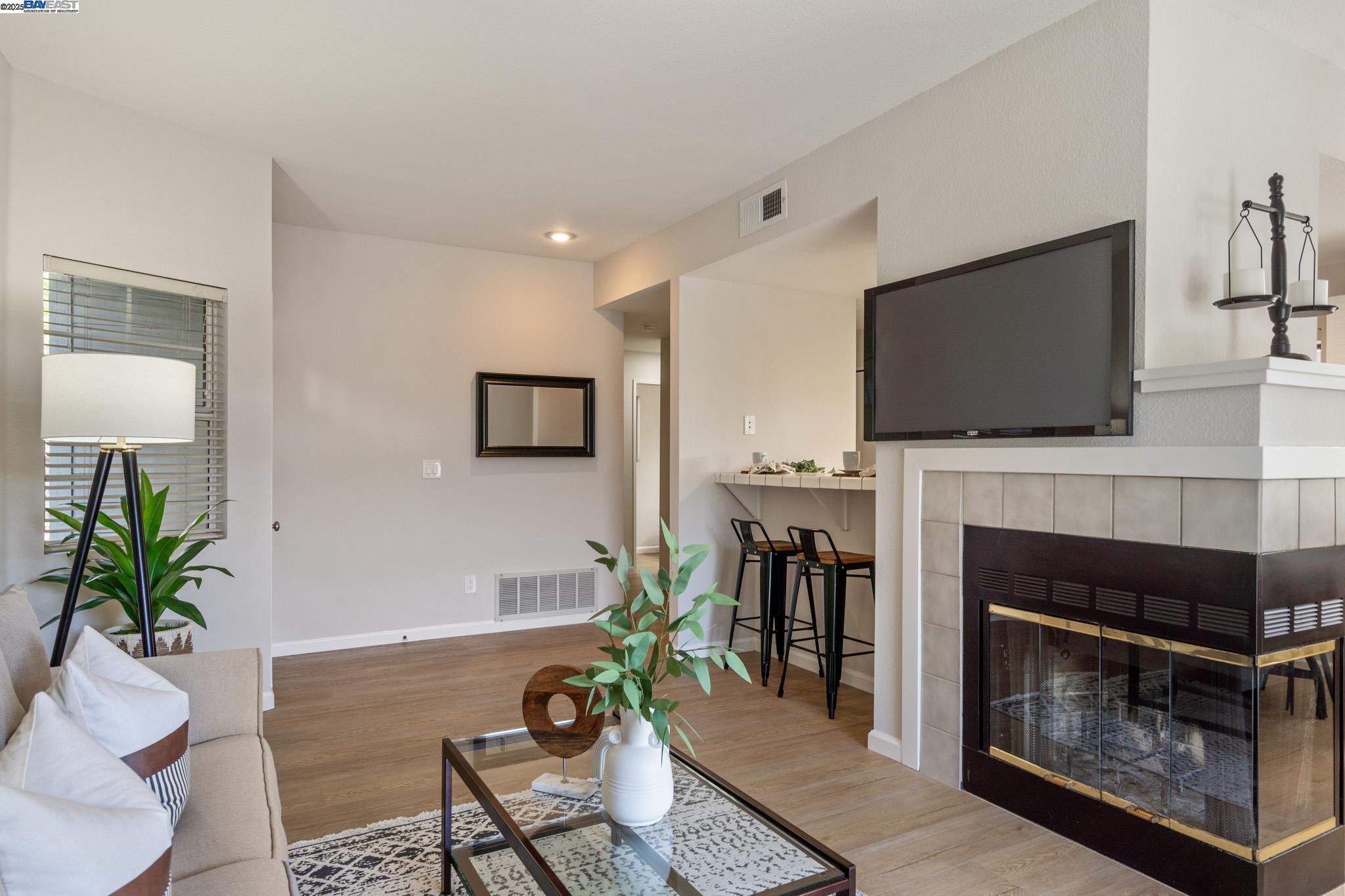 8165 Mountain View Drive, Unit C Pleasanton, CA 94588 - Photo 6 of 35 a living room with furniture a fireplace and a flat screen tv