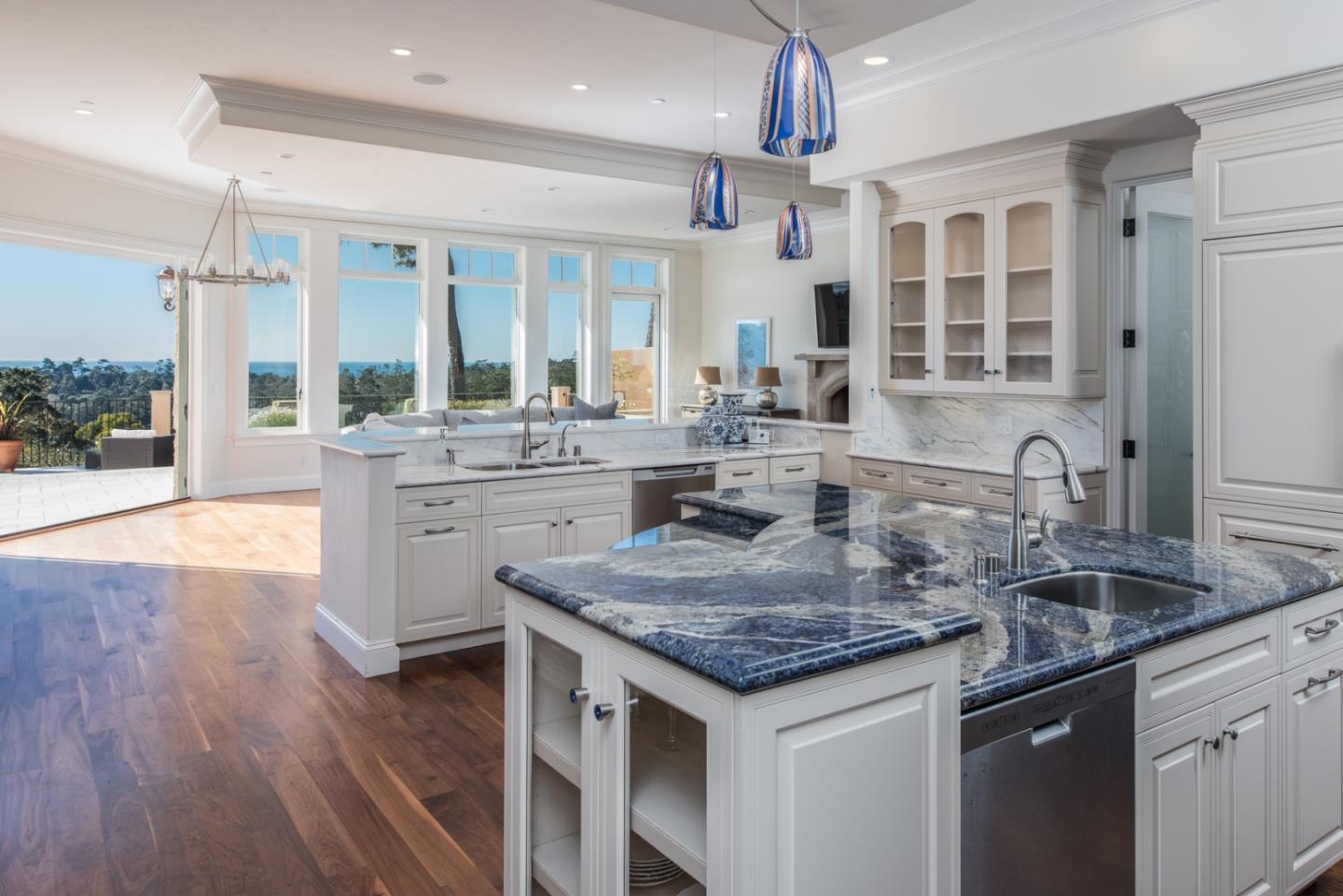 1451 Riata Road Pebble Beach, CA 93953 - Photo 6 of 18 a kitchen with center island wooden floor and a refrigerator