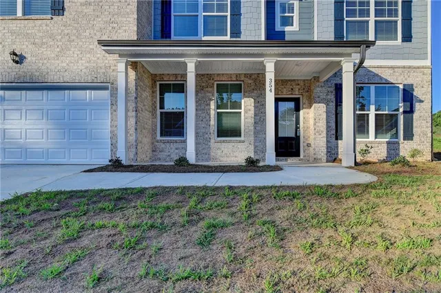 a view of a brick house with large windows