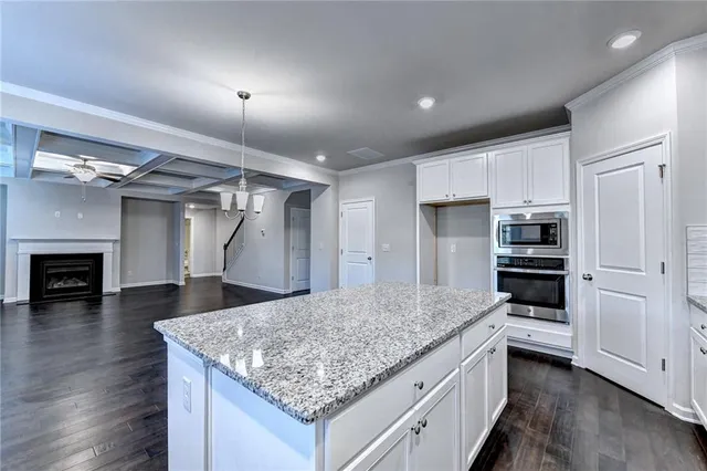 a kitchen with kitchen island a sink stainless steel appliances and cabinets