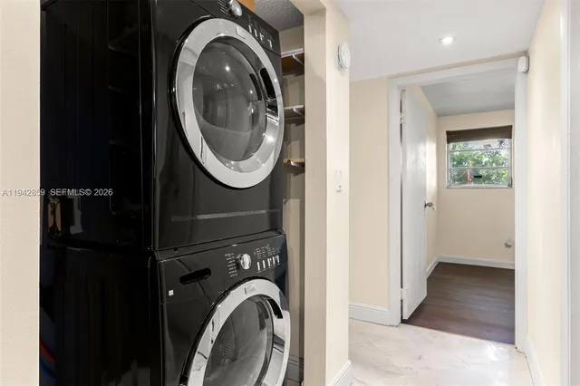 a view of a bedroom with washer and dryer