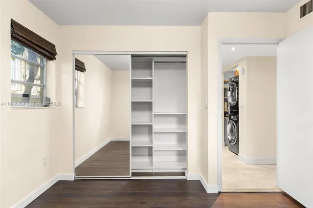 a view of a hallway with wooden floor and entryway