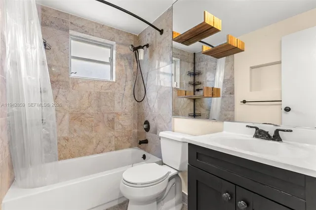 a bathroom with a sink toilet vanity and shower