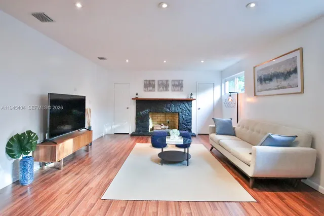a living room with furniture and a fireplace