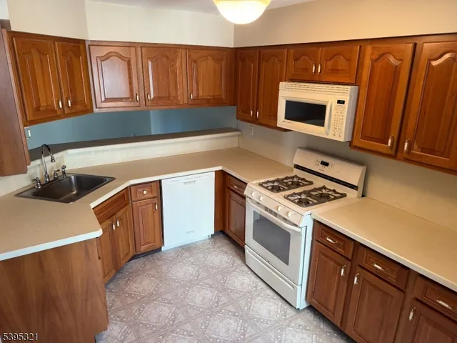 a kitchen with stainless steel appliances a stove a microwave and a sink